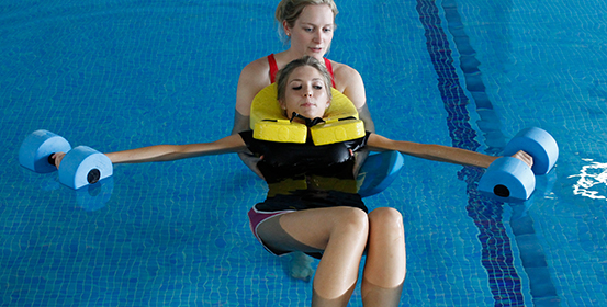 ManchesterOT therapist aids a patient during a hydrotherapy session with floats.