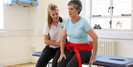ManchesterOT therapist uses physical aid to help improve patients condition.