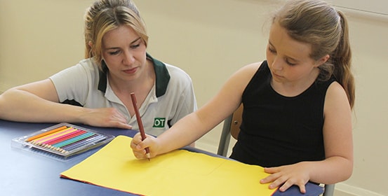 Young child gets help with improving her handwriting during a ManchesterOT therapy session.