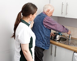 Elderly lady in care home with walking aid.