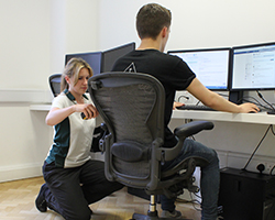 Woman laughing in office setting.