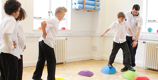 ManchesterOT paediatric group therapy session using colourful balance blocks.