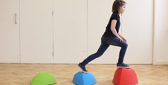 Young child using colourful stepping stones as part of her ManchesterOT therapy.